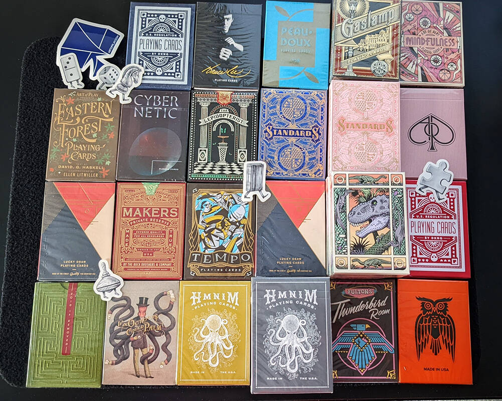 Unwrapped Mystery Decks from Art of Play, lined up in a grid pattern