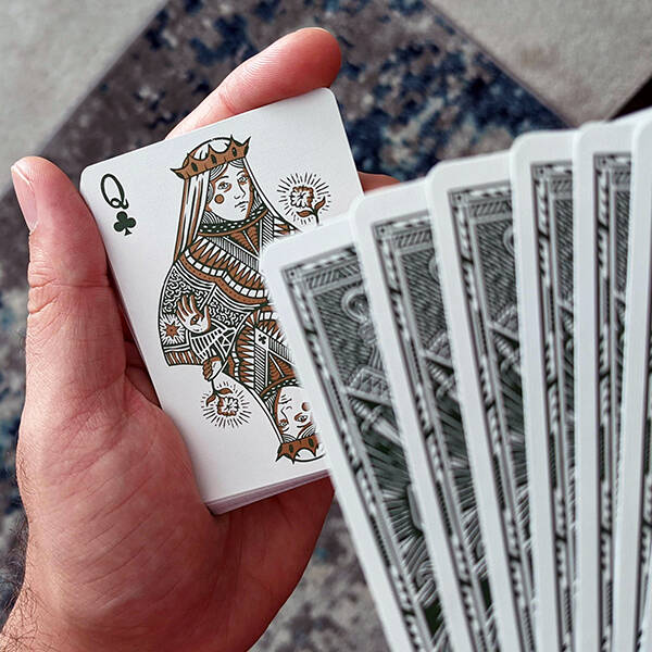 The Queen of Clubs, face up, from a spread of cards.
