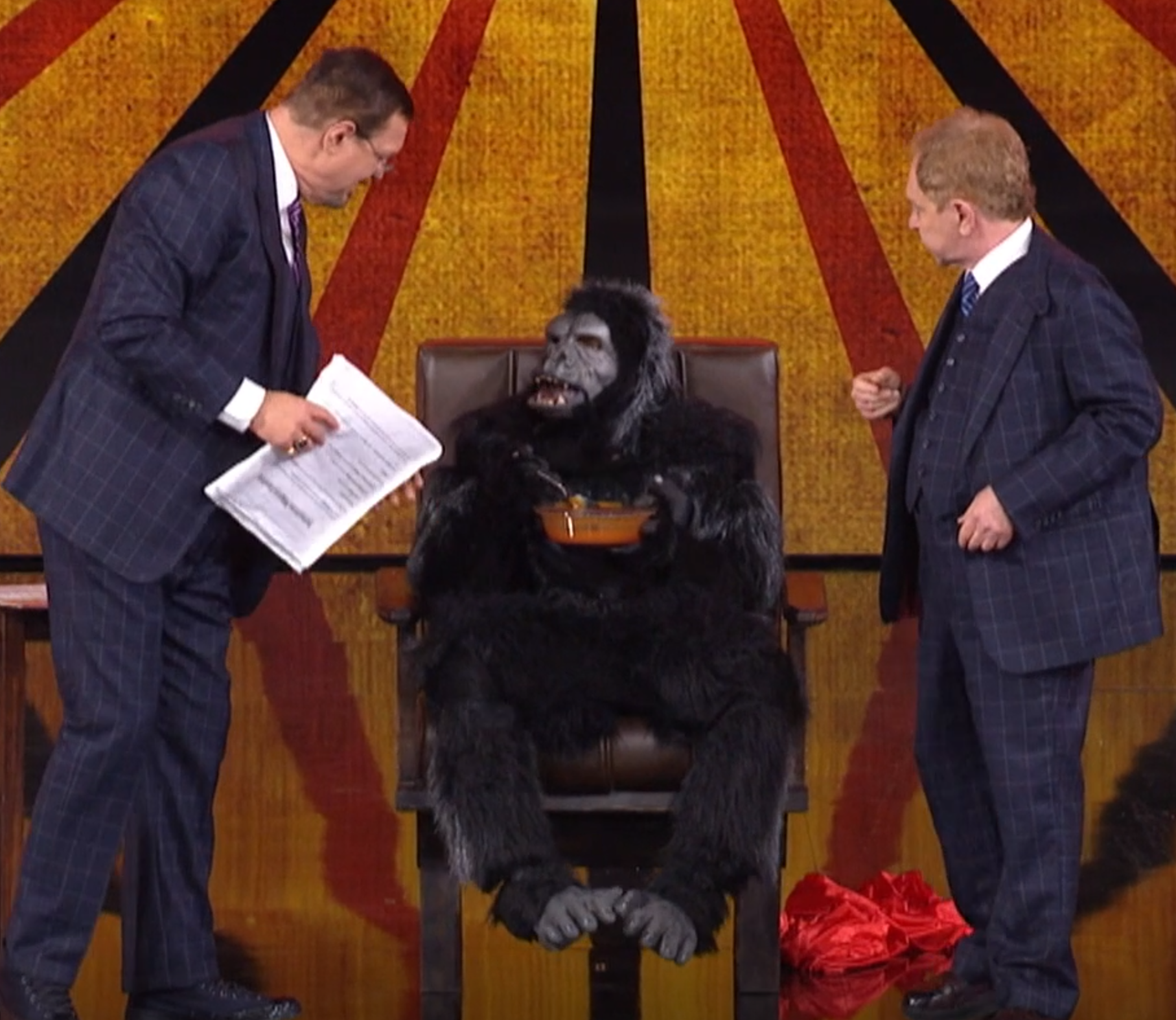 Penn, Teller, and a giant monkey eating soup.