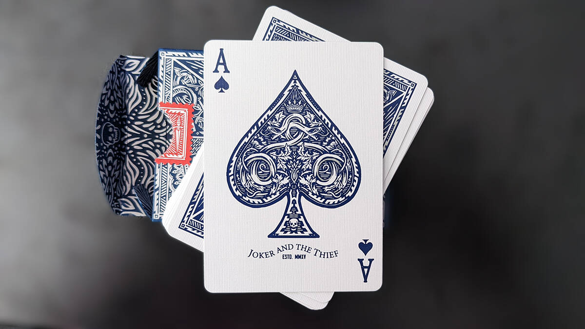 The detailed and custom Ace of Spades sitting on the face-down deck.